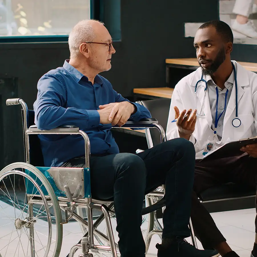 Dispatch Medical Transport, Inc. - elderly man in wheelchair, speaking with his doctor at appointment - Springfield, IL